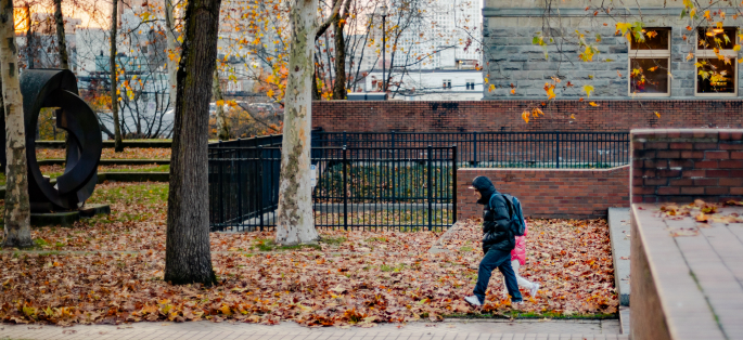 Seattle Central person walking outside among the leaves