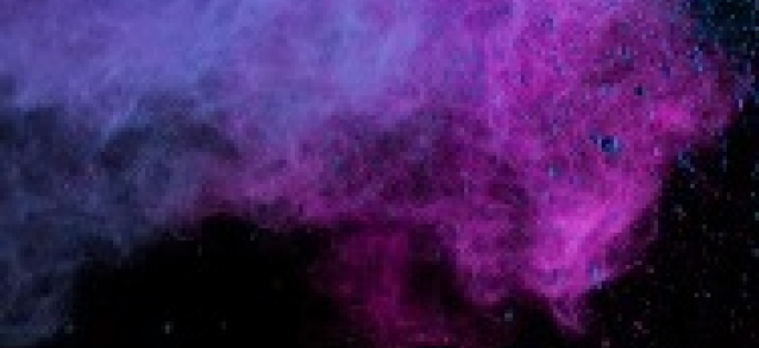 abstract decorative image of colored smoke in magenta, purple, and blue