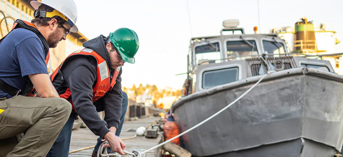 Seattle Central College Maritime students tying knots on a pier