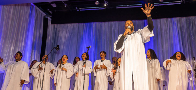 members of a gospel choir dressed in robes and singing