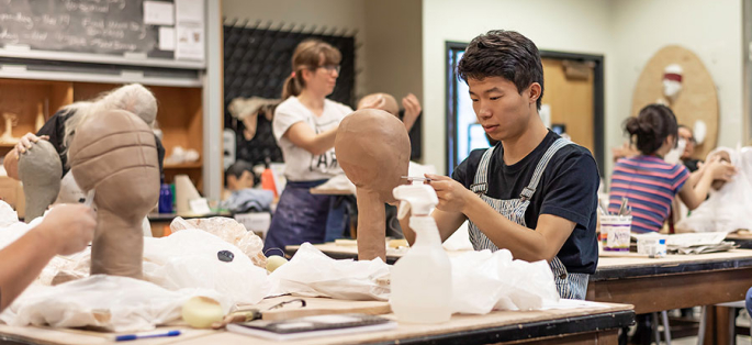 North Seattle College student working in ceramics class