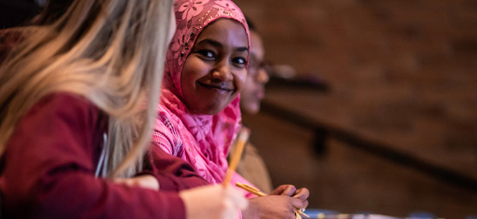 smiling student in a classroom setting 