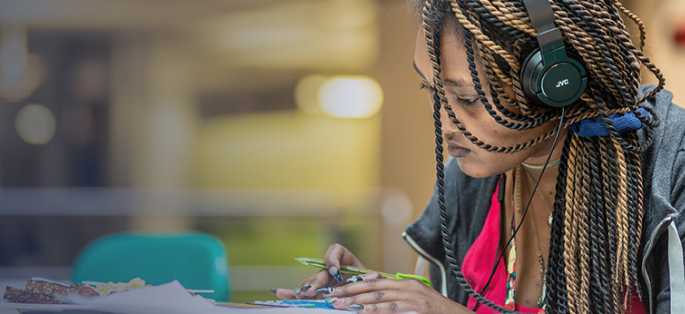 Seattle Central College student studying in the Atrium lunch area