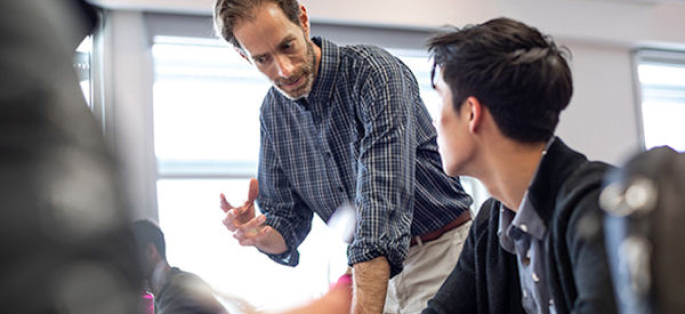 faculty member with student in a classroom