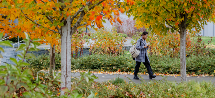 South Seattle student walking amidst fall colors