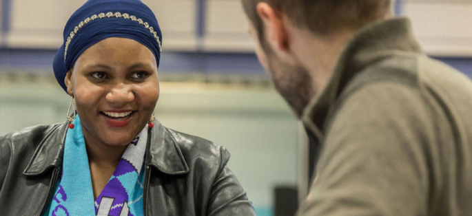 smiling staff member interacting with a student