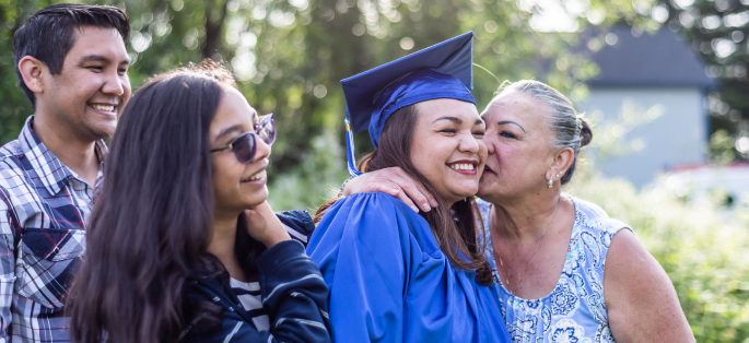 Student at commencement with family